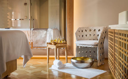Aman Venice wellness space with plunge pool, wooden accents, and neutral tones.