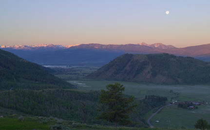 Moon rising over Jackson Hole valley at dusk from Amangani.