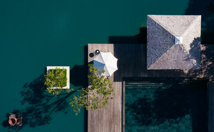 Aerial view of Amanyara's wellness facilities with wooden jetties extending into turquoise waters.
