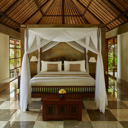 Principal bedroom with four-poster bed and wooden ceiling at Aman Villas at Nusa Dua.
