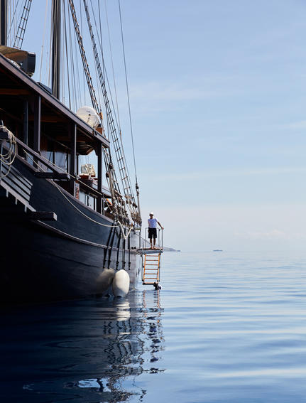 Exterior view of Amandira's vessel moored in calm blue waters.