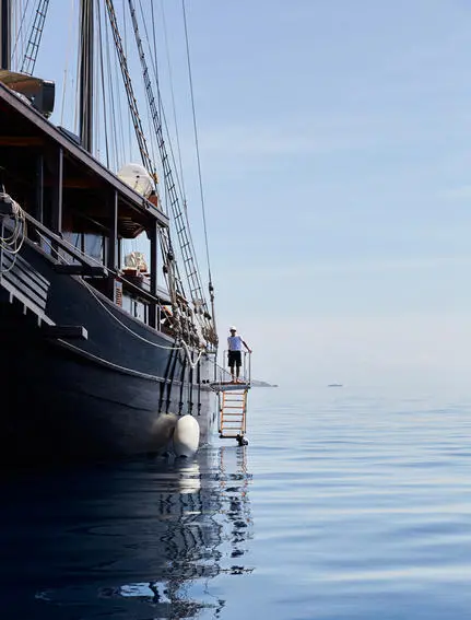Exterior view of Amandira's vessel moored in calm blue waters.