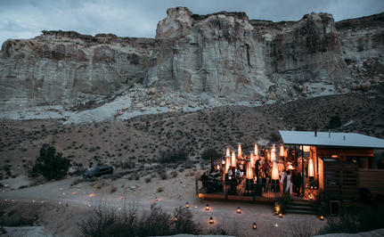 Amangiri's terracotta-hued pavilion glows warmly against desert cliffs at dusk in Chinle.