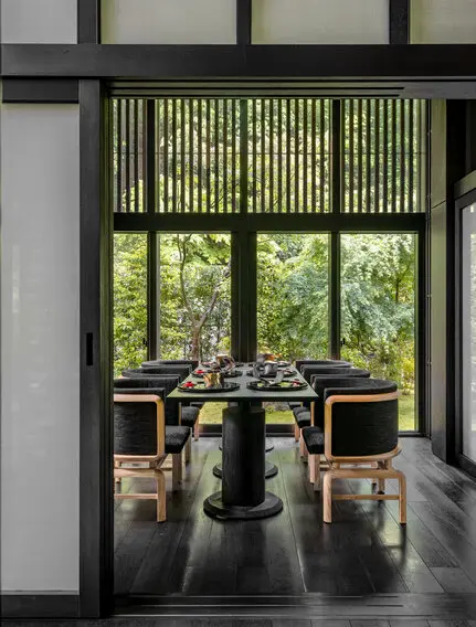 Taka-an private dining room at Aman Kyoto resort, with shoji screens framing garden views and a minimalist table setting.
