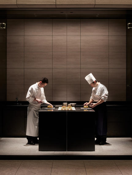 Two chefs at work in La Pâtisserie at Aman Tokyo, preparing pastries with precision and focus.