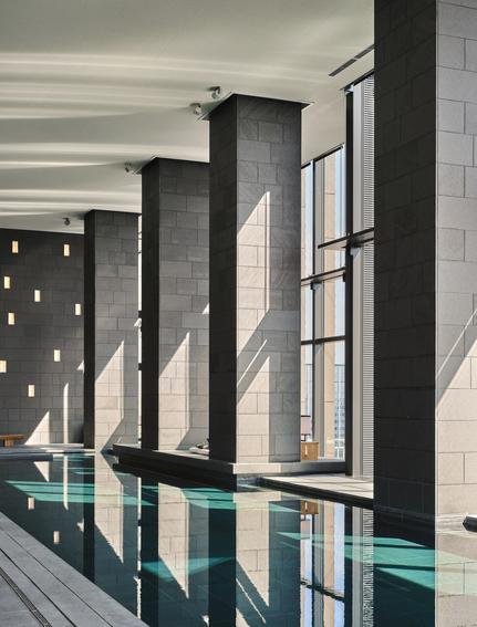 Aman Tokyo spa, reflection pool with tall stone columns and minimalist architecture.