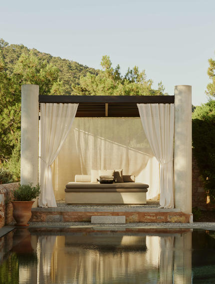 Garden View Pavilion with daybed beside reflecting pool at Amanruya, Turkey.