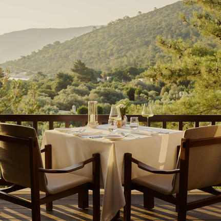 Private dining table set for wine tasting at Amanruya, Turkey, with mountain views.