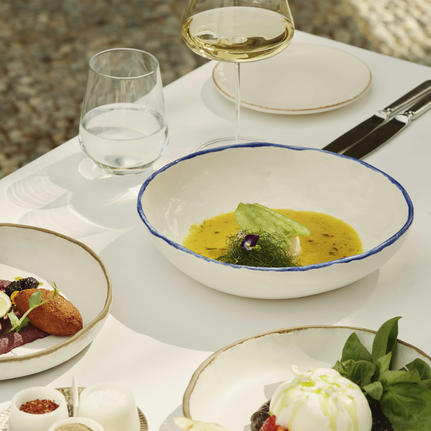 Turkish dining at Amanruya with fresh seafood and vegetable dishes elegantly plated on white tableware.