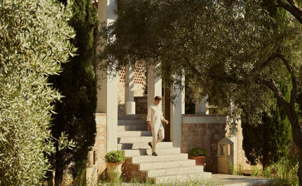 Stone villa entrance at Amanruya framed by olive trees.