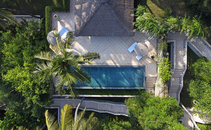 Aerial view of a suite at Amankila resort in Indonesia, featuring a plunge pool and lush tropical gardens.
