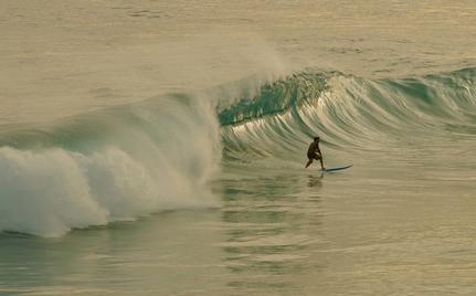 Surfer riding a wave at Amanera resort, Dominican Republic.