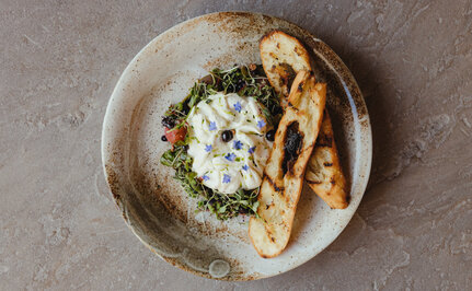 Burrata cheese on toasted bread with herbs, served at Amangani's dining venue.