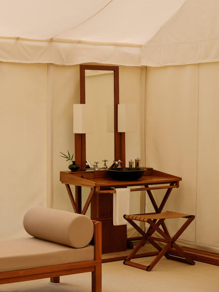 Bathroom vanity with mirror and wooden furnishings inside a tent at Aman-i-Khas.
