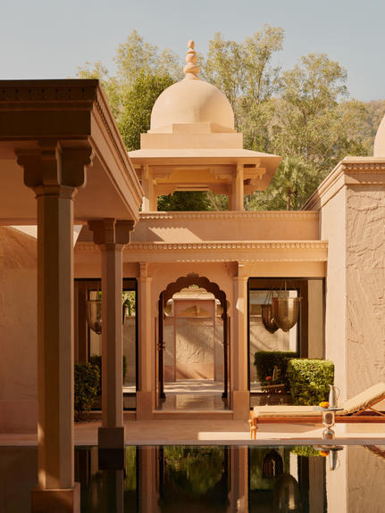 Pool pavilion exterior at Amanbagh with sandstone architecture and water feature.