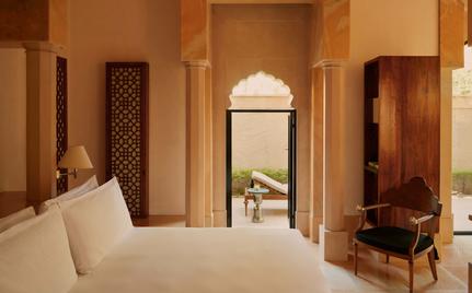 Courtyard Haveli Suite at Amanbagh with bed, archway, and traditional Indian architectural details.