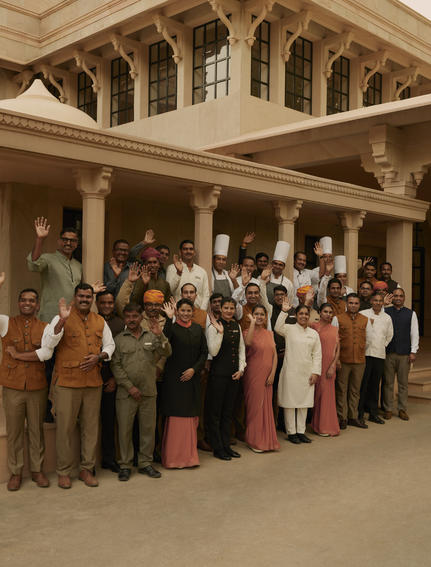 Group of hotel guests gathered in the courtyard at Amanbagh, Rajasthan.