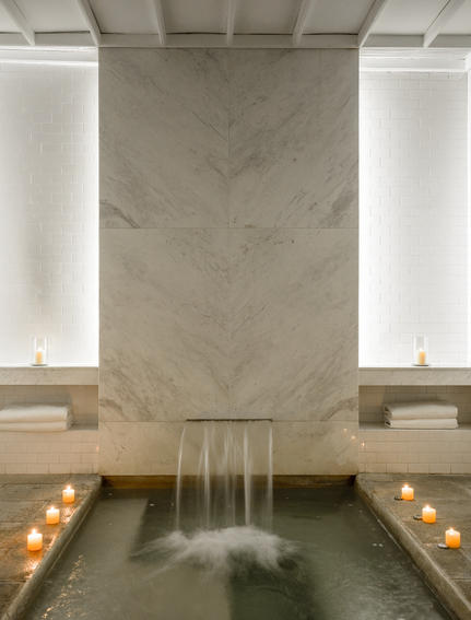 Spa plunge pool at Amangalla with marble walls and candlelit sides.