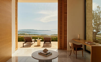 Four-bedroom villa interior at Amanzoe with terrace overlooking Aegean landscape.