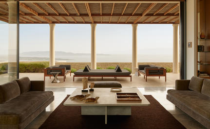 Four-bedroom villa living area with floor-to-ceiling windows overlooking the Aegean Sea at Amanzoe.