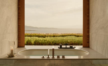 Four-bedroom villa bathroom at Amanzoe with stone vanity overlooking olive groves.