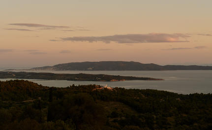 Four-bedroom villa view across the Aegean Sea at Amanzoe at dusk.