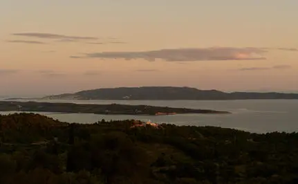 Four-bedroom villa view across the Aegean Sea at Amanzoe at dusk.