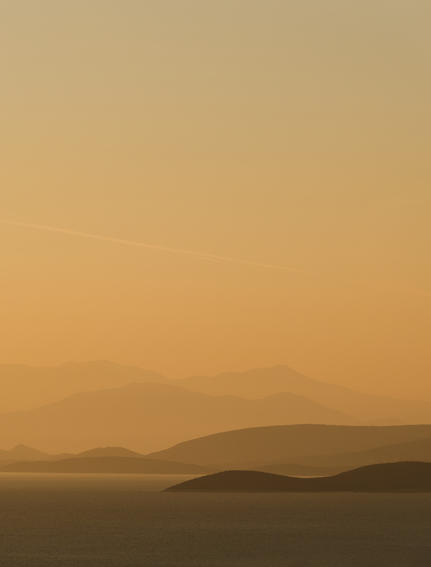 Golden sunset over Aegean islands at Amanzoe, Greece.