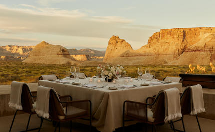 Private dining terrace at Amangiri overlooking desert rock formations at sunset.