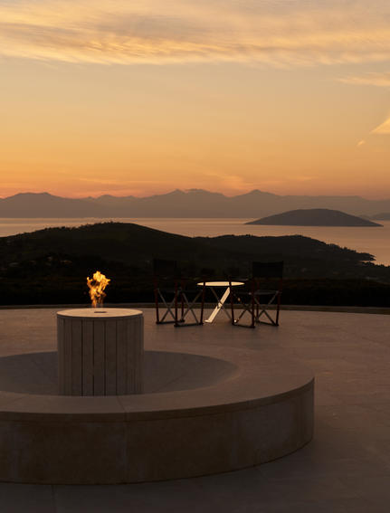 Candlelit table at sunset overlooking the Aegean Sea at Amanzoe.