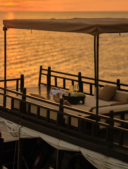 Wooden boat deck at sunset on the Tonlé Sap Lake, Amansara, Cambodia.