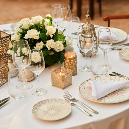 Maison Jardin dining table set with white flowers and place settings at Amanjena resort.