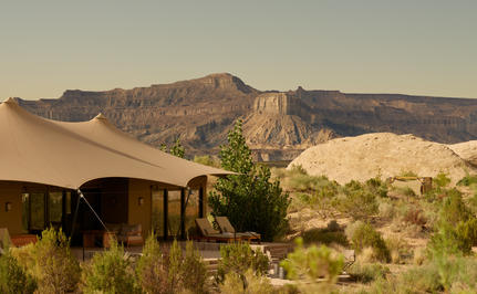 Canvas structures at Amangiri with views towards surrounding canyon landscape at sunrise.