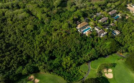 Aerial view of Aman Villas at Nusa Dua nestled amongst tropical forest and manicured grounds, Indonesia.