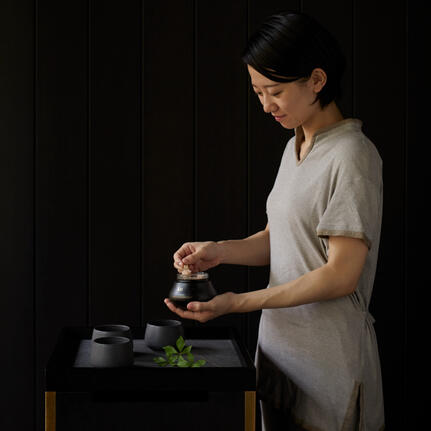 Therapist preparing a wellness treatment at Aman Kyoto spa in Japan.