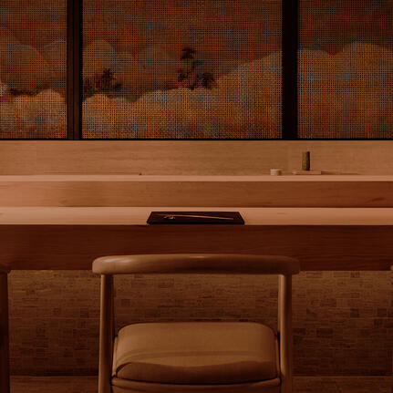 Wooden desk with chair and mirror at Aman Nai Lert Bangkok.