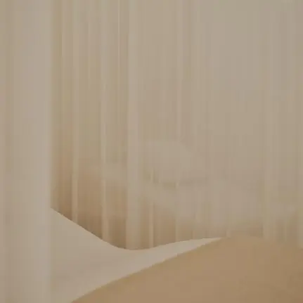 Spa and wellness area at Aman Le Mélézin with soft, draped fabrics and warm neutral tones.