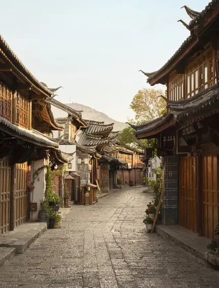 Stone-paved street lined with traditional wooden buildings in Lijiang Old Town, Amandayan.