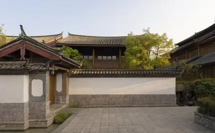 Courtyard at Amandayan with traditional Chinese architecture, curved rooflines, and stone pathways.