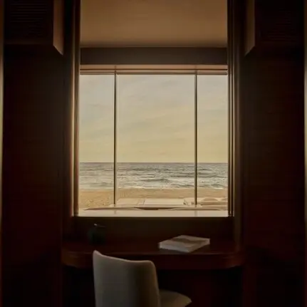 Beachfront casita at Amanvari with ocean view through window and desk seating.