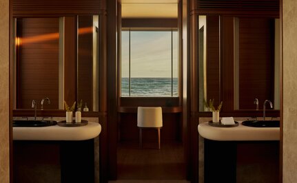 Bathroom with dual vanities and warm wood cabinetry at Amanvari, Mexico.