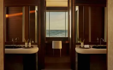 Bathroom with dual vanities and warm wood cabinetry at Amanvari, Mexico.