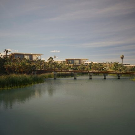 Casita exterior overlooking a tranquil river and distant landscape at Amanvari, Mexico.