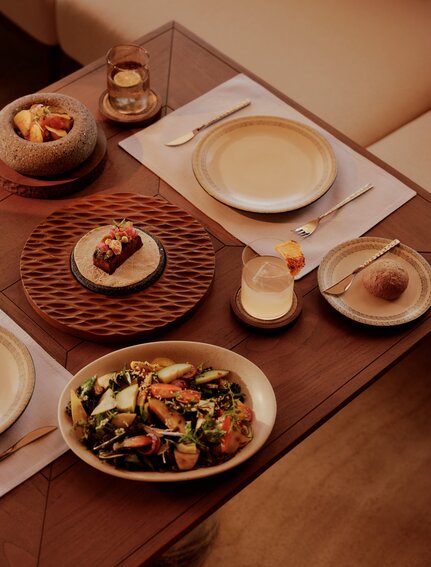 Amanvari beach club dining table with Mexican-inspired dishes and earthenware serving pieces.