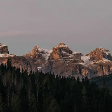 Jagged mountain peaks of the Dolomites at dusk, viewed from Aman Rosa Alpina resort.