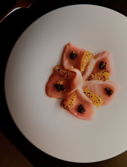 Plated dessert with red fruit coulis and gold leaf at Amanvari, Mexico.