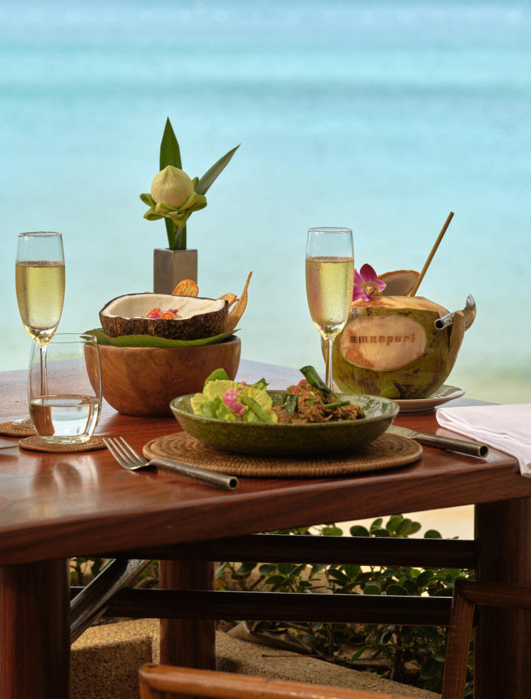 amanpuri_thailand_-_dining_beach_terrace_table_setup_view_coconut_champagne.jpg