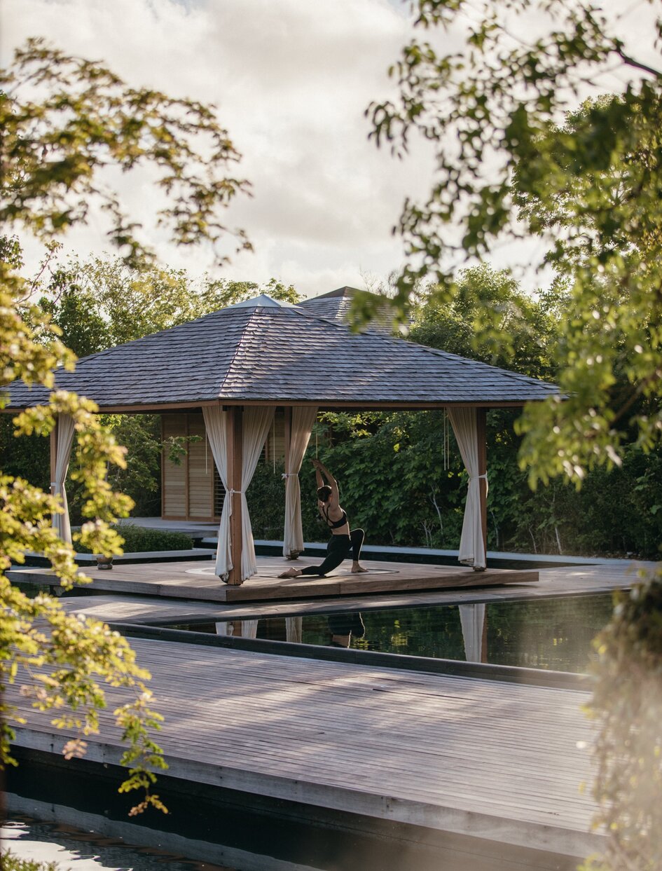 Spa pavilion at Amanyara with reflecting pool, surrounded by tropical vegetation in Turks & Caicos.