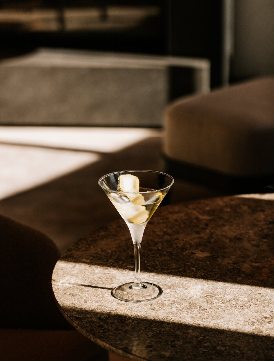 Martini cocktail on marble table at Il Salotto bar, Aman Rosa Alpina.