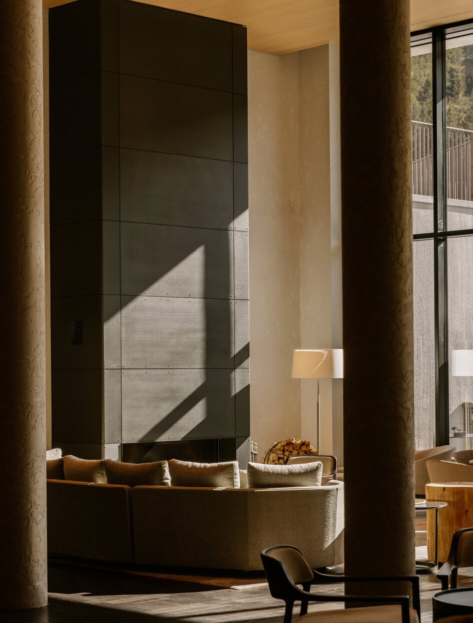 Winter garden at Aman Rosa Alpina with dark architectural feature and warm lighting.